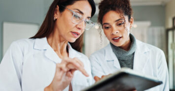 Tablet, women and ophthalmologist in clinic for vision discussion, planning treatment or eyesight test results. Digital technology, optometrist and store for eye health, collaboration or medical team.